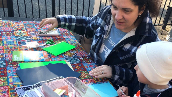 Student and parent making Valentine's card