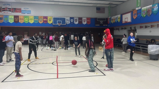 Students playing four square