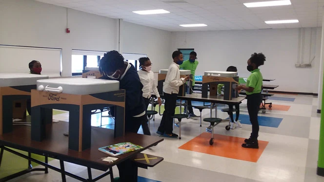 Students assembling air filtration systems