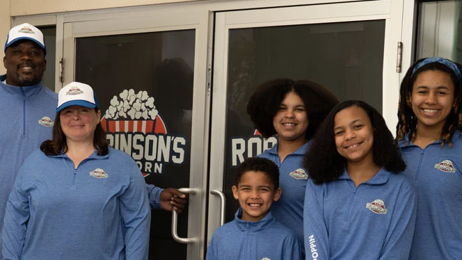 Virtual K-12 School in Grand Rapids: Robinson Family in front of their store.
