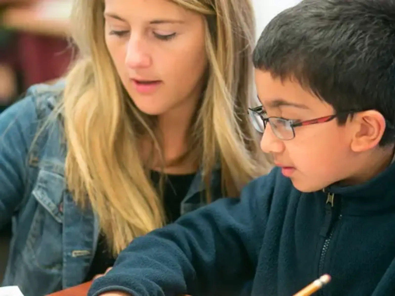 K-8 School in Canton: Teacher working with student in classroom.