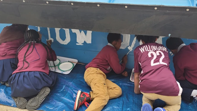 Students painting plow blade.