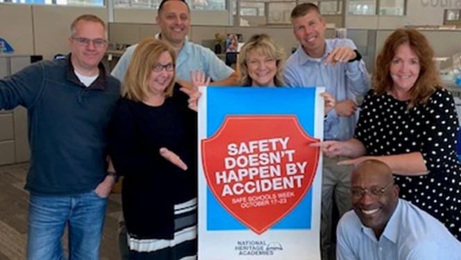 People around a sign that says Safety Does Not Happen By Accident. People around a sign that says Safety Does Not Happen By Accident.