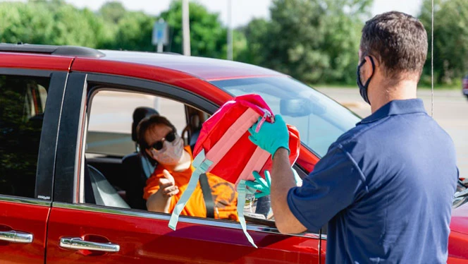 Student receiving a backpack