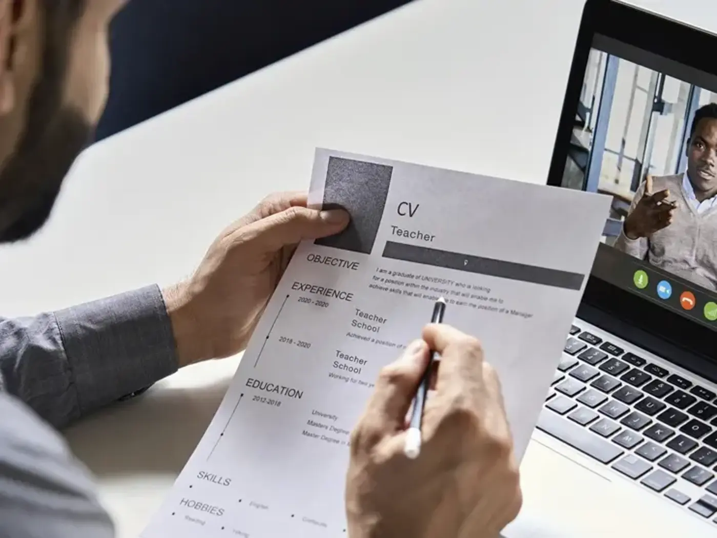 man reviewing resume on virtual interview