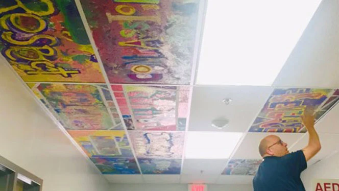 Student paintings being added as ceiling tiles. Student paintings being added as ceiling tiles.