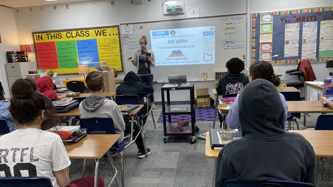 A teacher presenting to her class. A teacher presenting to her class.