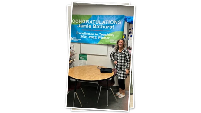 Teacher with winner banner.
