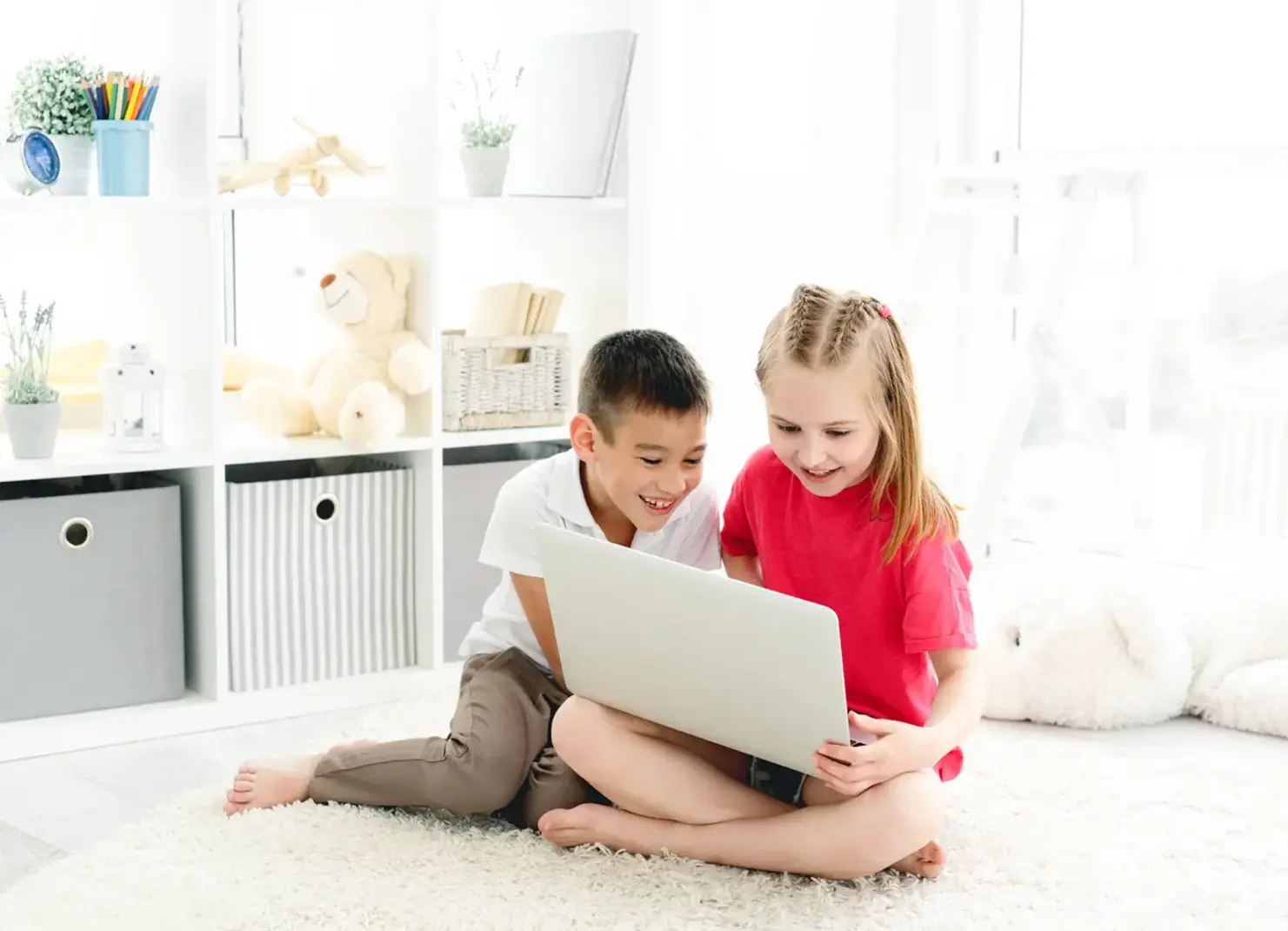 Two students sitting at a computer smiling.
