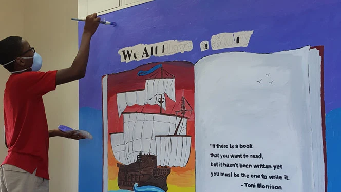 students painting a mural