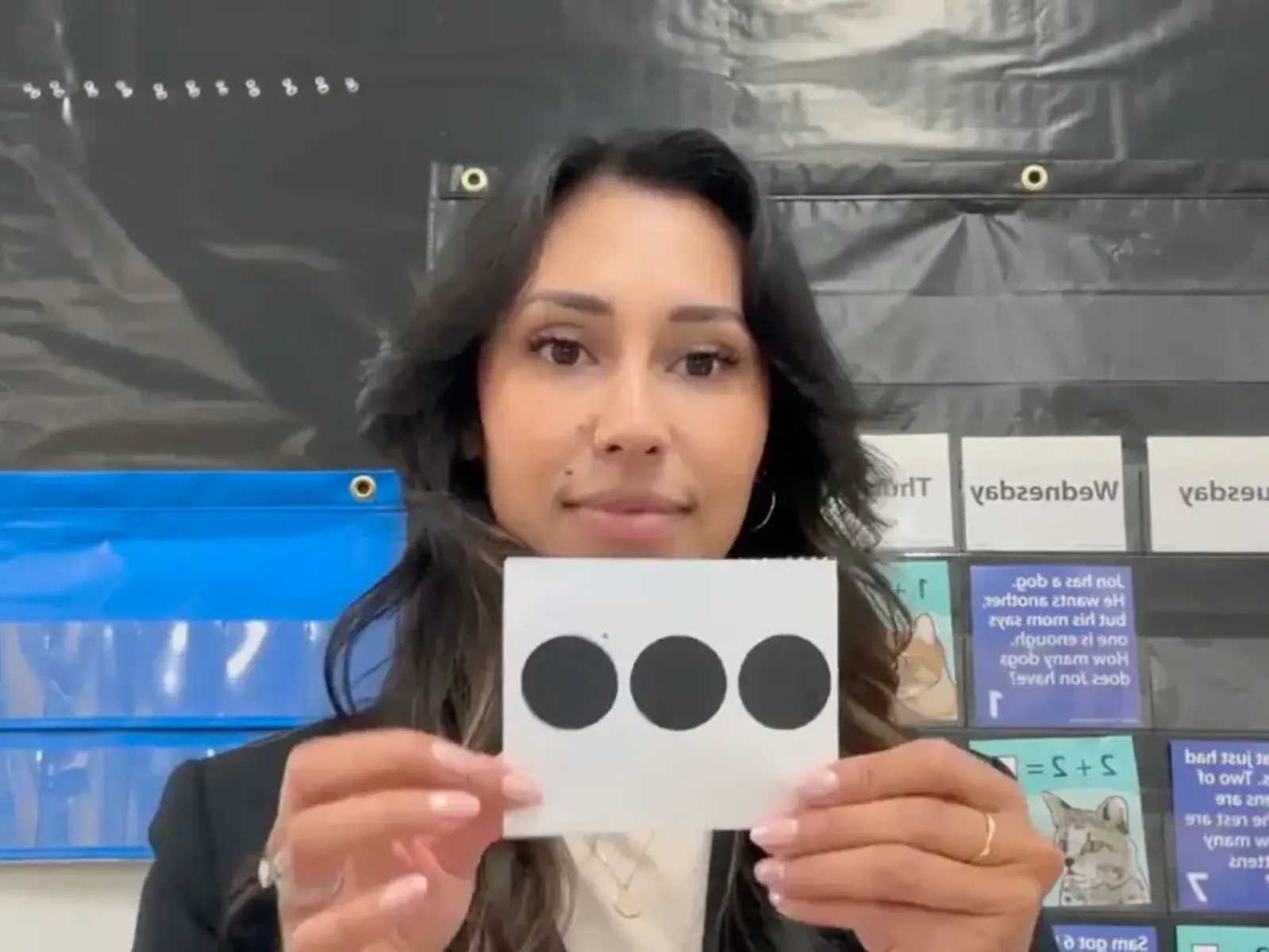 Teacher holding up flashcard with three circles
