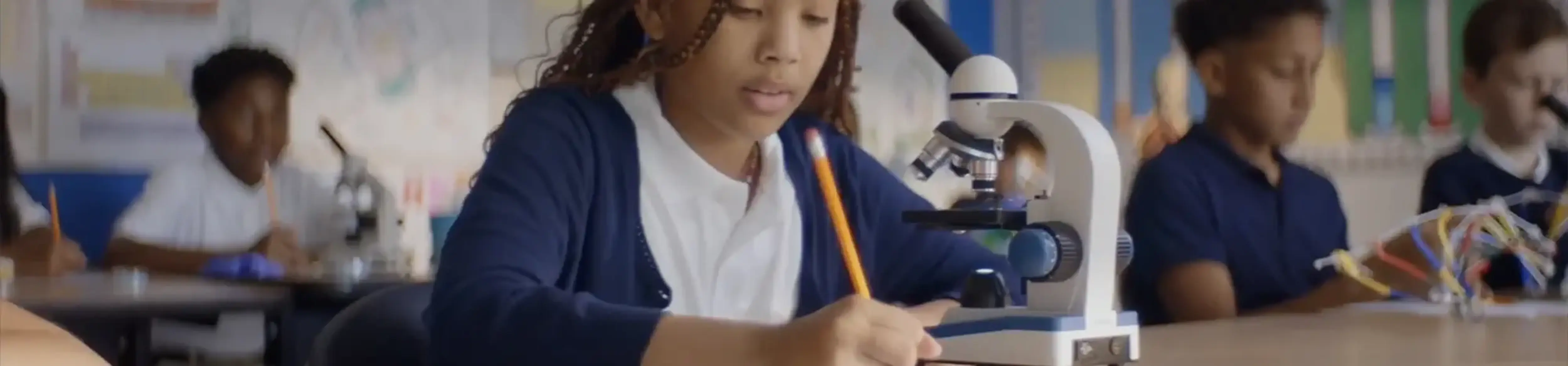 Student studying at a microscope