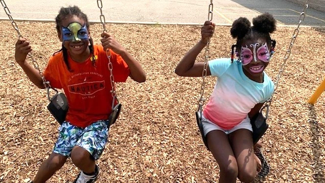Students with their faces painted.