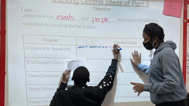 Child writing on a whiteboard. Child writing on a whiteboard.