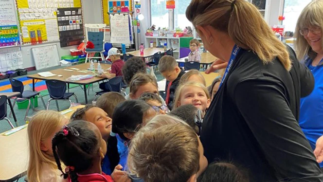 Kim Bondy hugging students.