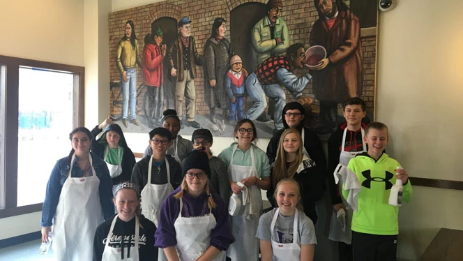 A class wearing aprons. A class wearing aprons.
