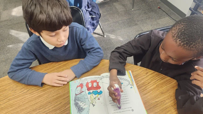 Two students coloring.