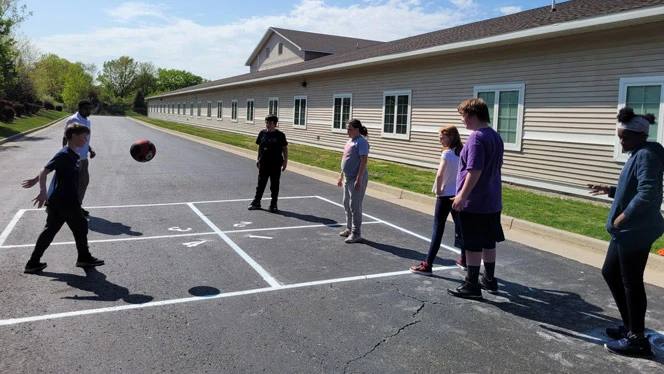 Quest students playing four square
