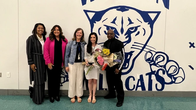 Rachel Licata holding flowers with others.