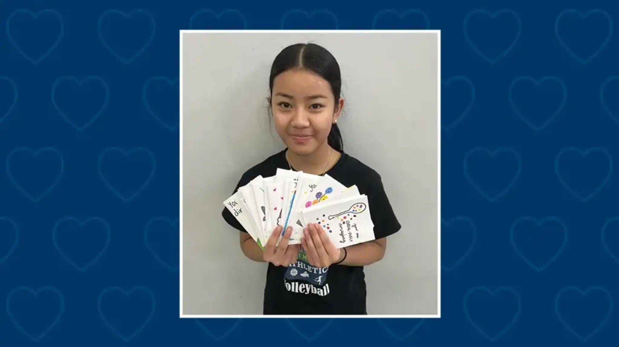 a girl holding a fan of cards
