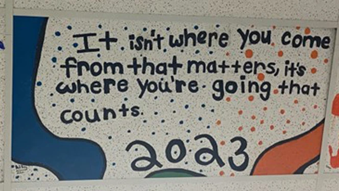 Writing on a ceiling tile.