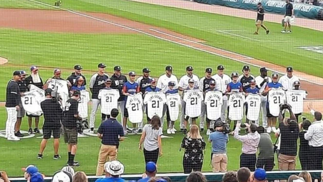boys in a line holding baseball jerseys