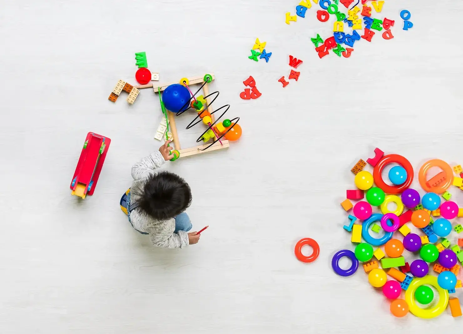 Child playing with colorful toys.