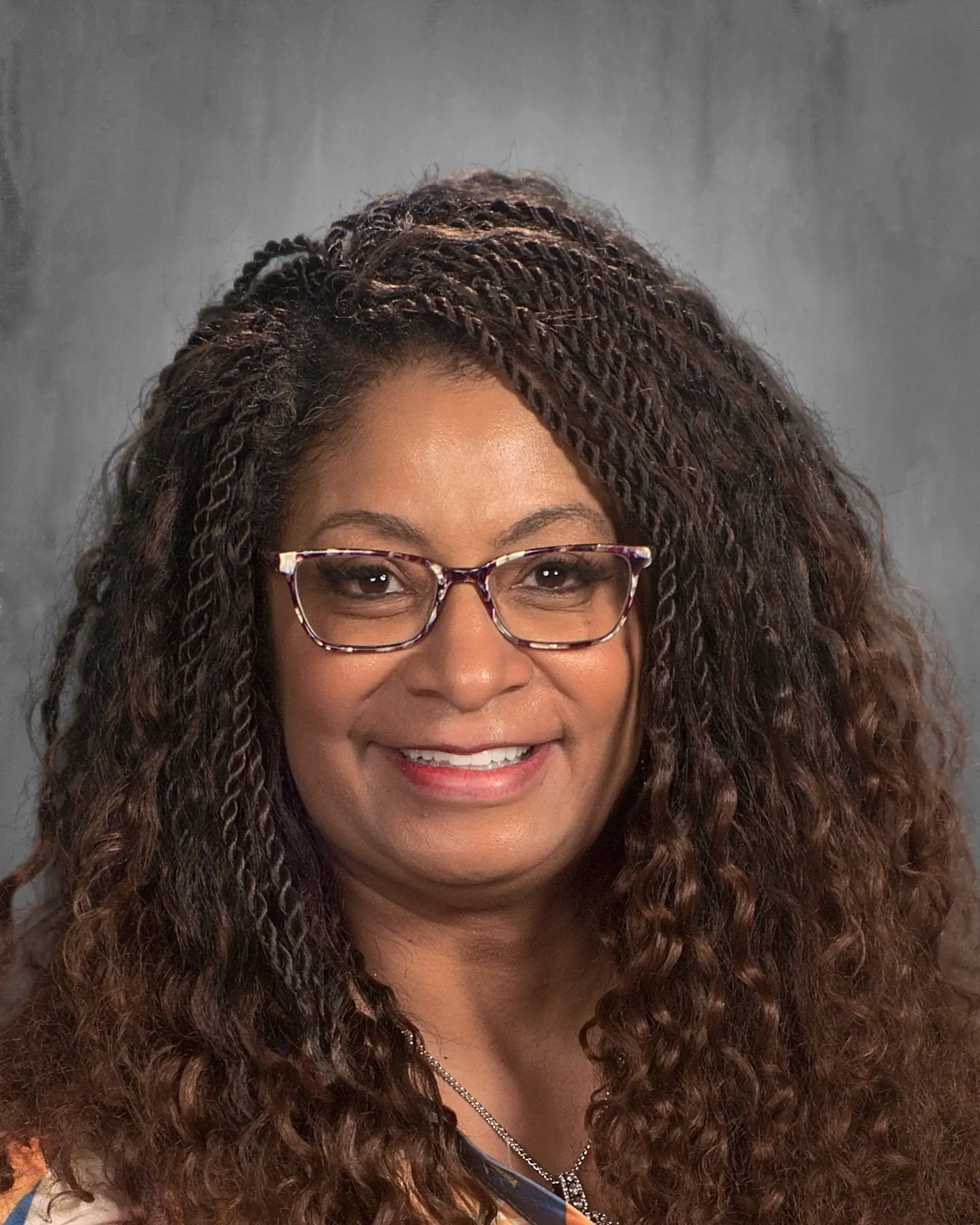 a woman with curly hair wearing glasses