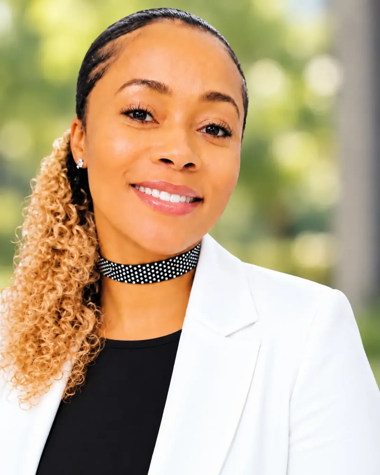 women smiling wearing a white blazer
