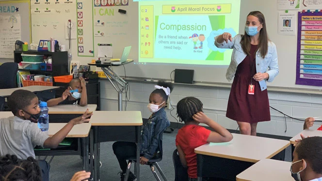 A teacher calling on a student. A teacher calling on a student.