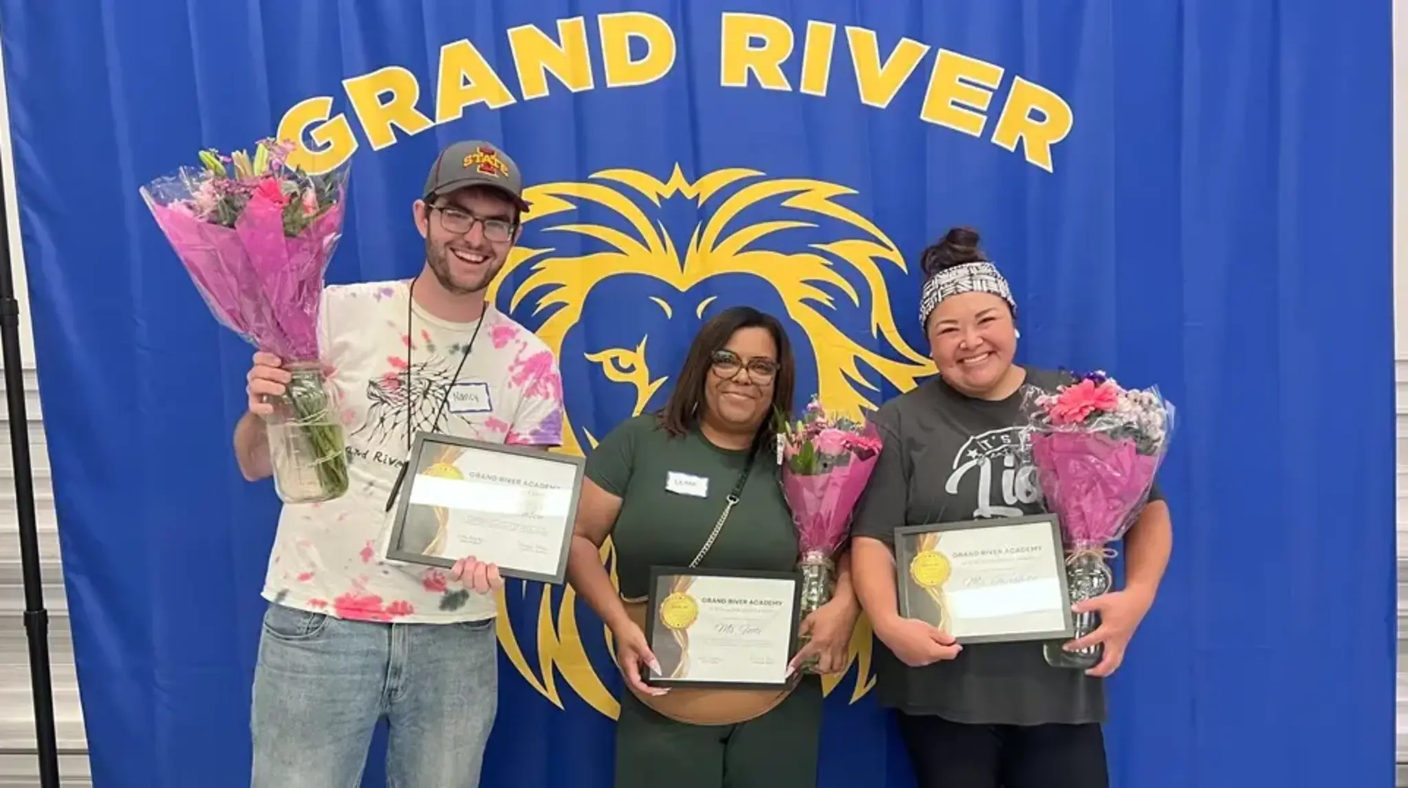 a group of people holding certificates