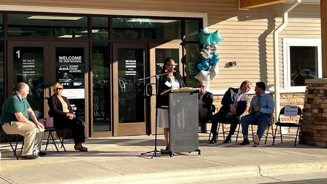 Brown speaking at a podium