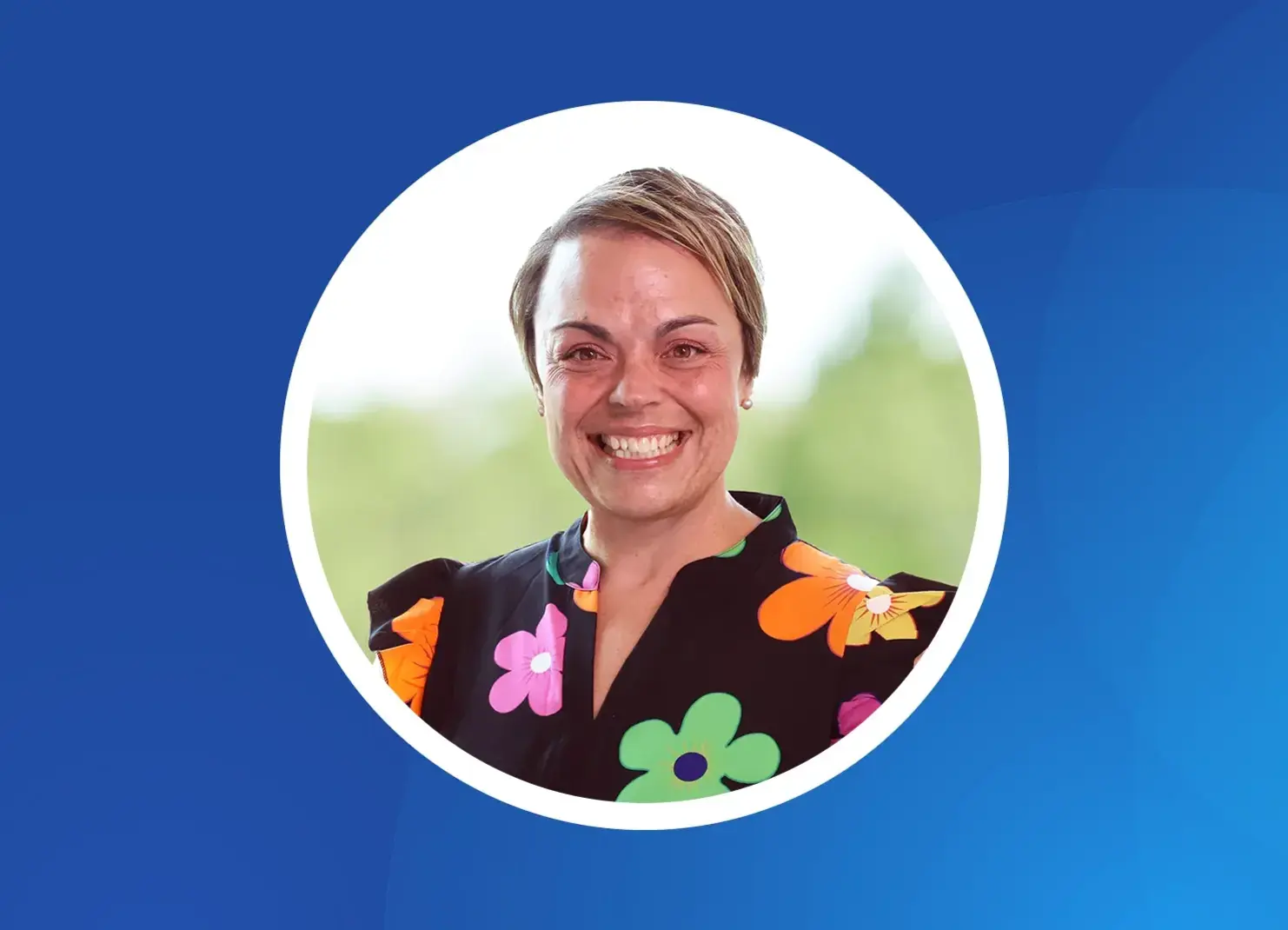a woman smiling with a blue background