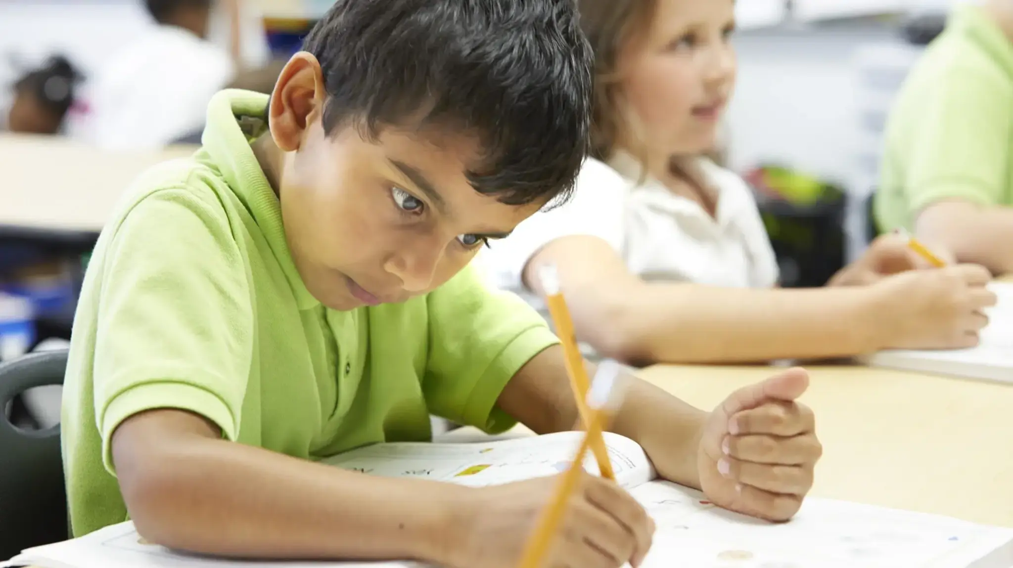 a boy writing on a paper