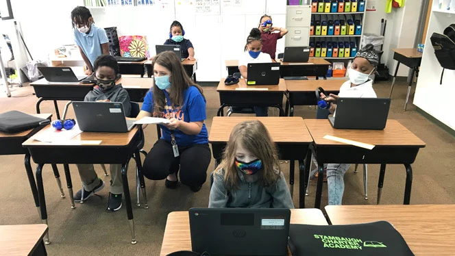 Children in masks learning. Children in masks learning.