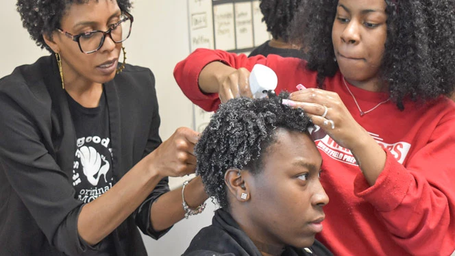 Westfield Prep students learning techniques for their hair.