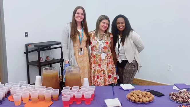Teachers handing out food and drinks.
