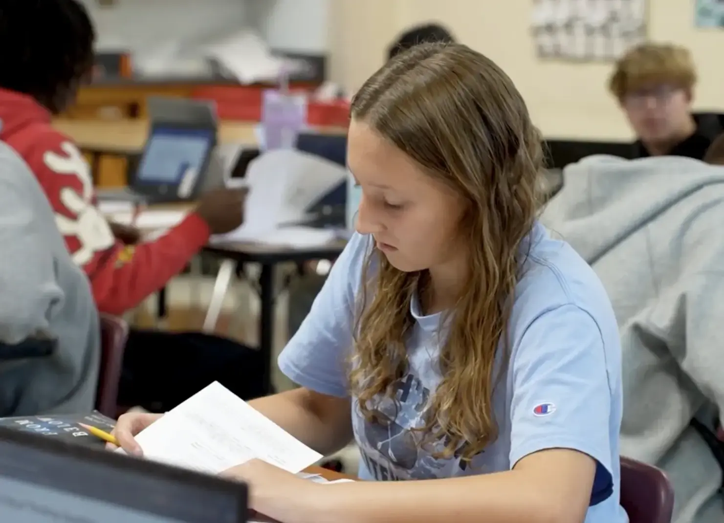 Student sitting in class working.