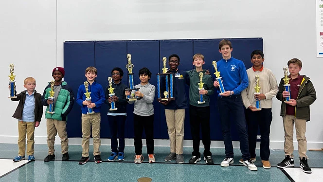 Students pose with trophies