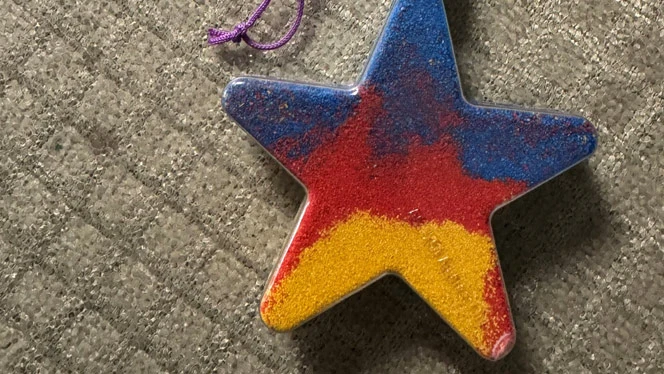 A student created a star from sand art.