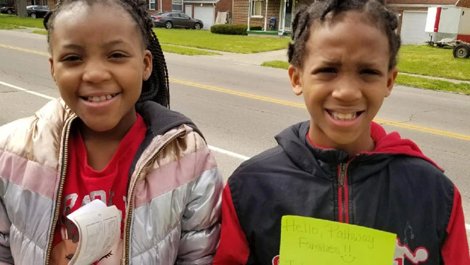 Pathway students holding notes