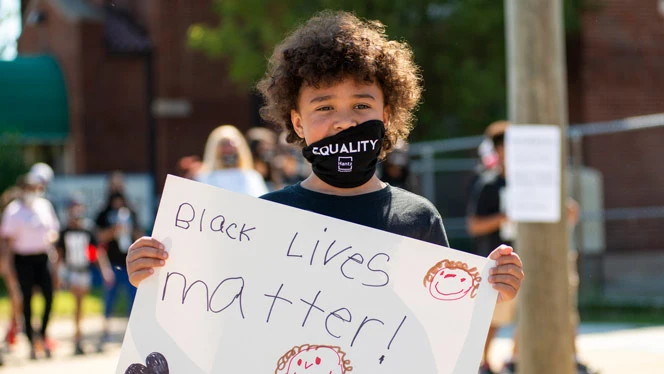 Detroit eEnterprise student holding a poster
