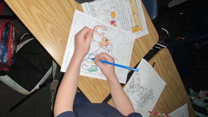 Student coloring Pokemon sheet.