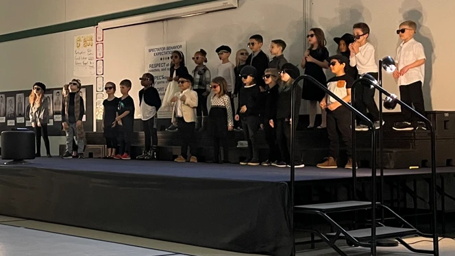 Children performing on stage.