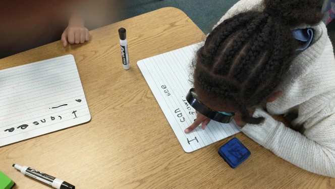 Student using magnifying glass. Student using magnifying glass.