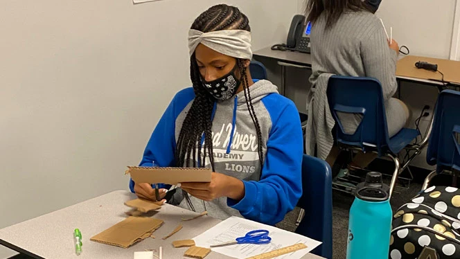 Student working on her science project. Student working on her science project.