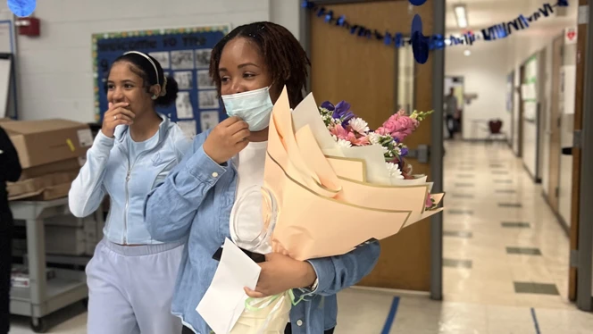 Nickiesha Grey holding award and flowers