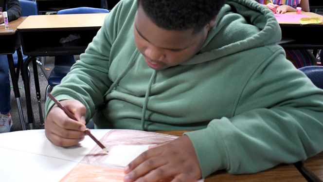 Student learning at a table.