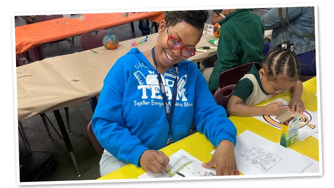 Ms. Berkeley-Cummins coloring with student.