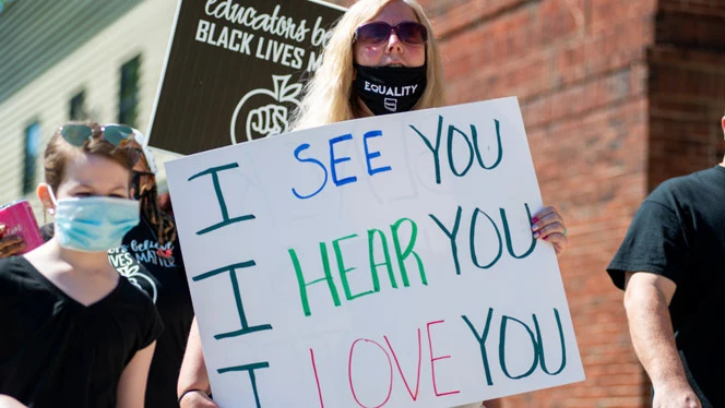 Detroit Enterprise staff holding support signs